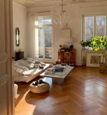 Sunlit living room with soft drapery and warm interior design